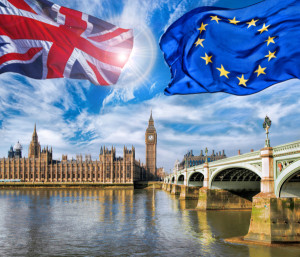 European Union and British Union flag flying against Big Ben in London England UK Stay or leave Brexit
