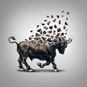 Fragile bull market financial crisis concept as an economic symbol for a crumbling positive forecast and investments falling apart due to valuation loss in the stock market.
