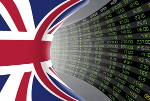 Flag of the United Kingdom with a large display of daily stock market price and quotations during economic booming period. The fate and mystery of the UK stock market tunnel/corridor concept.