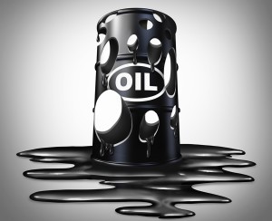 Oil collapse industry concept as a barrel full of holes of crude petroleum with liquid spilled on the floor as a business metaphor for energy price drop.