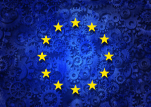 European business concept as a group of machine gears with the flag of europe as a concept for the economy and a financial system icon.