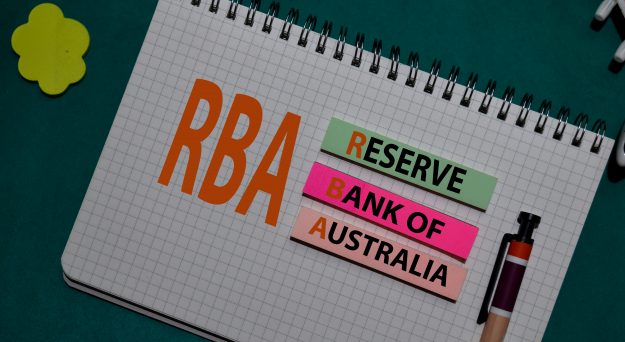 Australian dollar slides as RBA holds rates